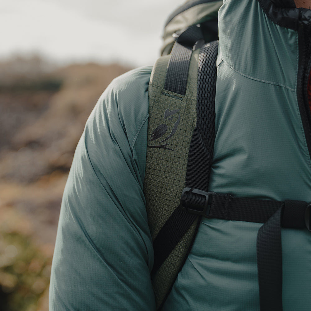 Close-up of Nebo Windbreaker and backpack strap, Detail view of Nebo Windbreaker shoulder and pack strap