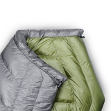 Close-up of a gray and green backpacking quilt showing the unique taper that causes the quilt to wrap naturally around your shoulders.