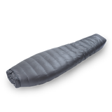 Diagonal view of a gray backpacking quilt fully closed, showing its tapered mummy-style shape and closed footbox.