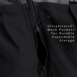 Close-up of the Shadowlight 60 backpack’s stretch mesh front pocket with vertical zipper for additional storage access.