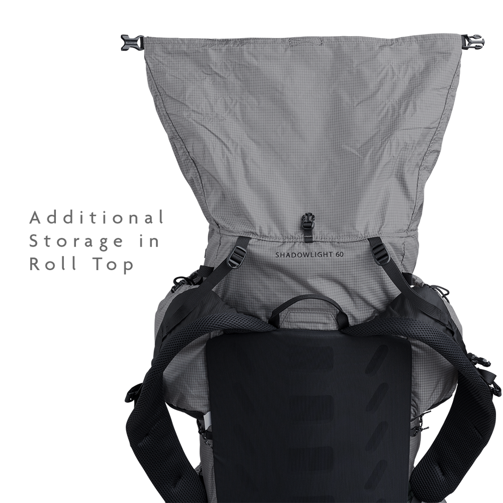 Rear view of the Shadowlight 60 backpack with roll-top closure open, showing main compartment expansion capacity.