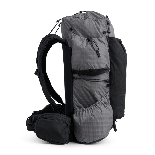 Side view of the Outdoor Vitals Shadowlight backpack showing large side pockets, hip belt pocket, and streamlined suspension system.