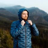 man adjusts hood on blue puffy down jacket