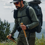 close side view of green fleece hoodie on man while he's hiking