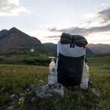 front view of CS40 Ultra Back sitting on stones in high mountain basin at sunrise