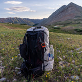 rear view of CS40 Ultra Backpack set down on stones in high mountain basin