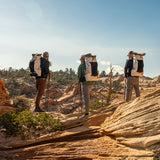 rear view of 3 men wearing the same ultralight backpack in sandstone terrain