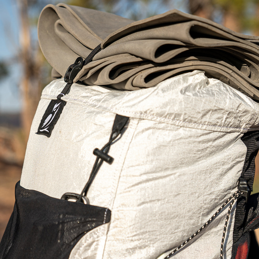 close side view of CS40 Ultra Backpack with closed cell foam pad strapped on top