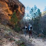 2 men hike down sandy trail with CS40 Ultra Backpacks