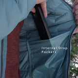 Close-up of insulated jacket interior showing large internal drop pockets holding a smartphone for easy storage and warmth.