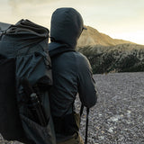 rear view of man wearing hybrid fleece hoodie on mountain peak
