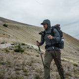 side view of man hiking up steep and exposed mountain slopes
