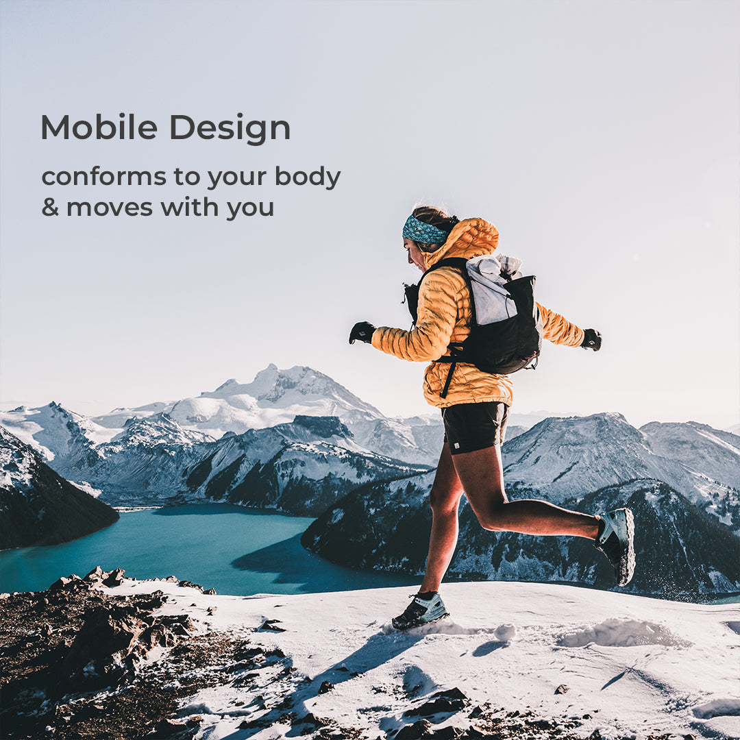 side view of runner on high snowy peak wearing technical backpack for hiking. Text on screen says, "Mobile Design - conforms to your body & moves with you."