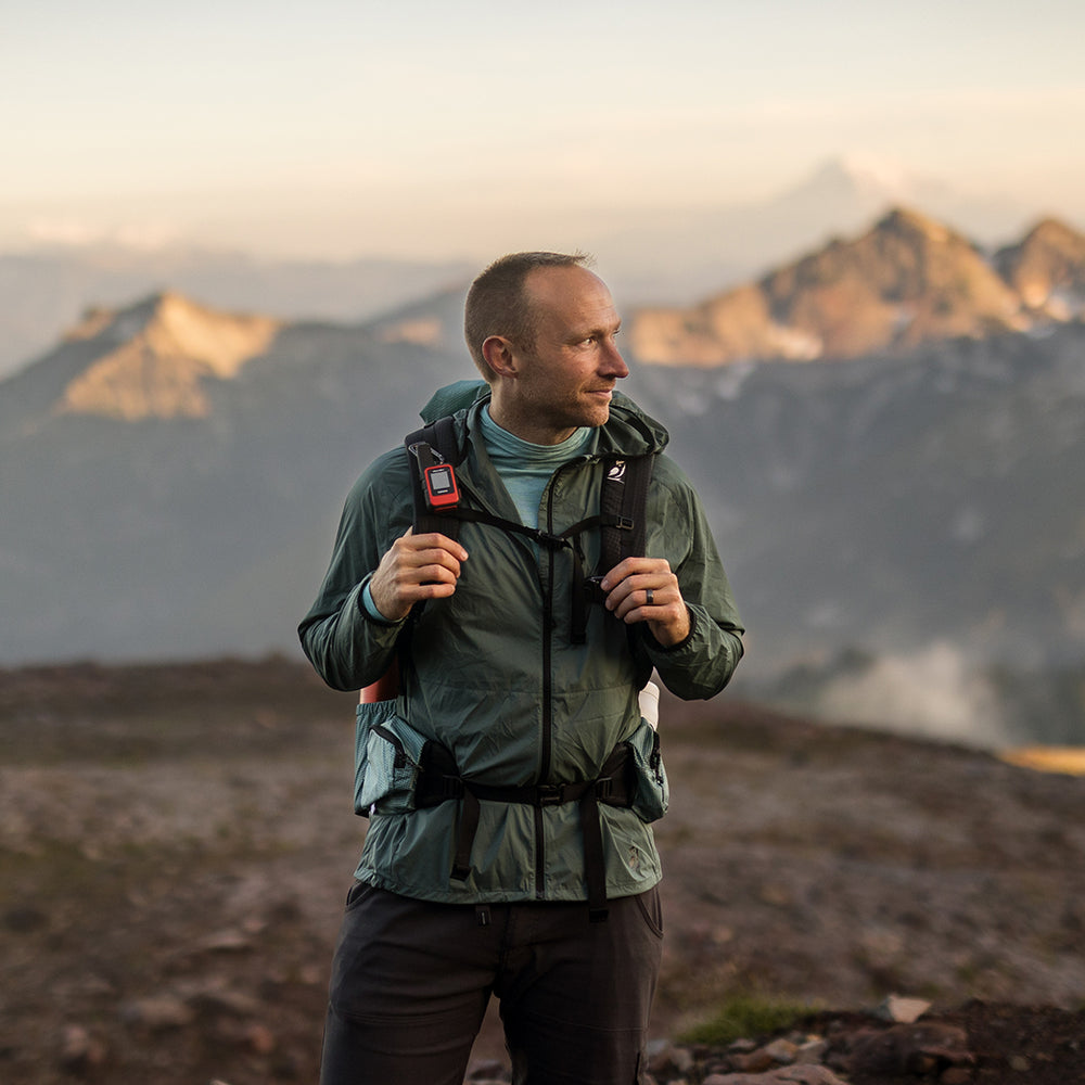Hiker wearing the Nebo Windbreaker in the mountains, Nebo Windbreaker on trail