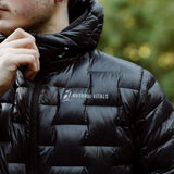 Close-up of a person adjusting the hood of a black NovaPro down insulated jacket, highlighting the brand logo and quilted Zero Stitch fabric.