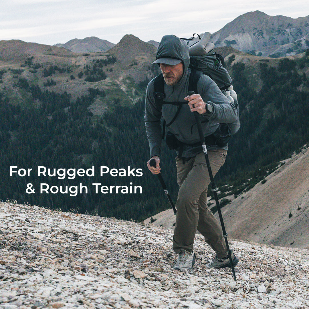 man hikes up steep mountain incline while wearing lightweight pants