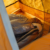 side view of woman sleeping inside down sleeping bag in her tent