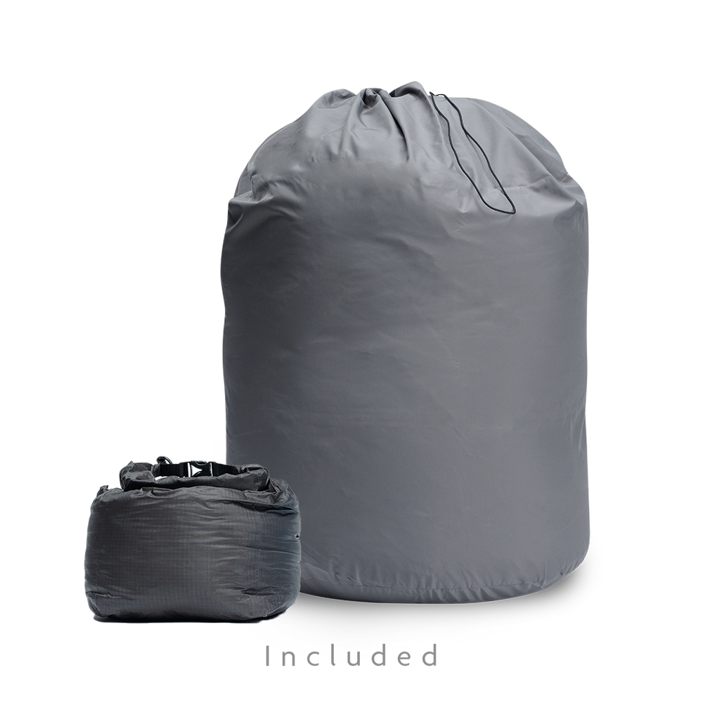 Two gray storage bags for a backpacking quilt: a large drawstring long-term storage sack and a smaller compressible stuff sack.