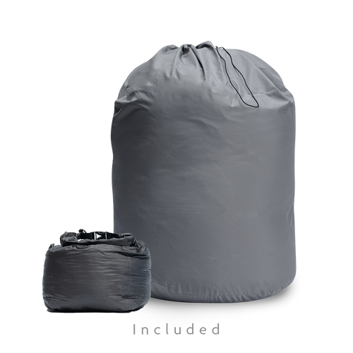 Two gray storage bags for a backpacking quilt: a large drawstring long-term storage sack and a smaller compressible stuff sack.