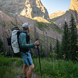 side view as hiker looks up at rocky mountain peaks while wearing CS40 Ultra Backpack