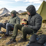 Hikers staying warm in Outdoor Vitals Vantage Alpine Down Jackets while eating and relaxing outdoors in rugged alpine terrain.