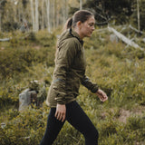 woman hiking with olive colored active mid layer side view
