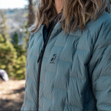 Close-up of women’s insulated Zulu Down Jacket showing Outdoor Vitals logo and Zero Stitch™ baffle design.