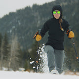 woman wearing black active mid layer while snowshoeing front view