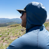 Close-up side view of the Altitude Sun Hoodie’s hood design while overlooking mountain scenery.