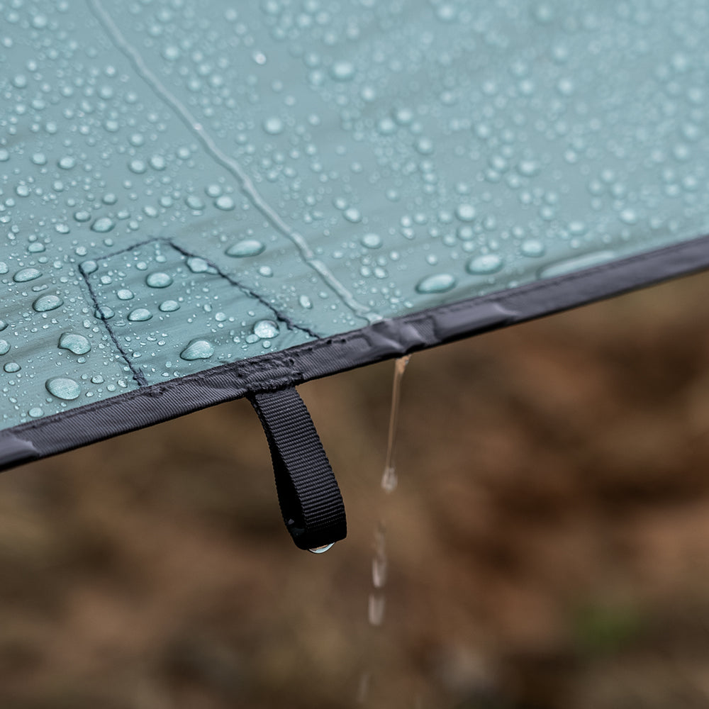 close view of water beading up & rolling off ultralight tarp fabric