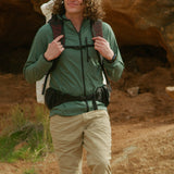 Hiker wearing Nebo Windbreaker with backpack on trail