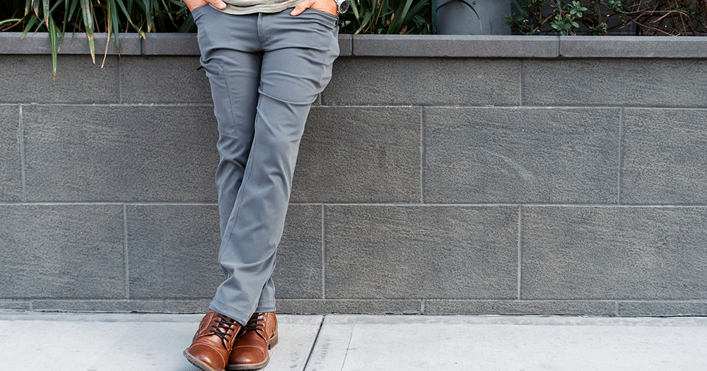 front view of man wearing charcoal trail pants in the city