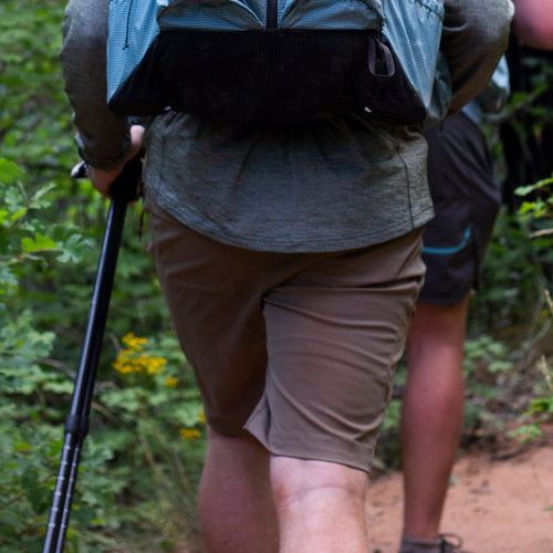 rear view of man wearing hiking shorts on trail