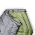 Close-up of a gray and green backpacking quilt showing the unique taper that causes the quilt to wrap naturally around your shoulders.