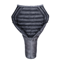 Top-down view of a backpacking quilt partially open, showing its black insulated interior and gray tapered footbox.