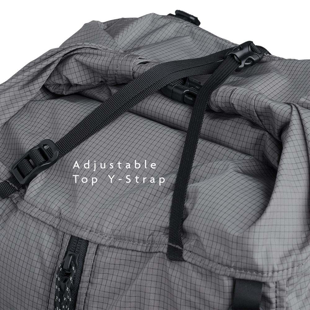 Close-up of the Outdoor Vitals Shadowlight backpack’s roll-top closure with adjustable top strap and buckle for secure compression.