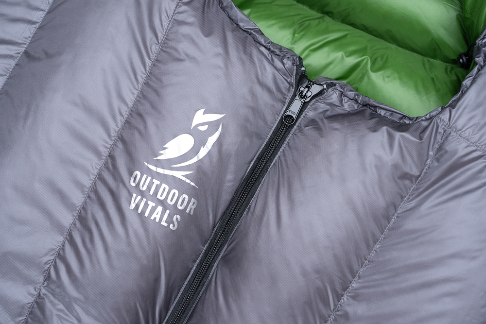 close view of zipper & logo on the front of ultralight sleeping bag