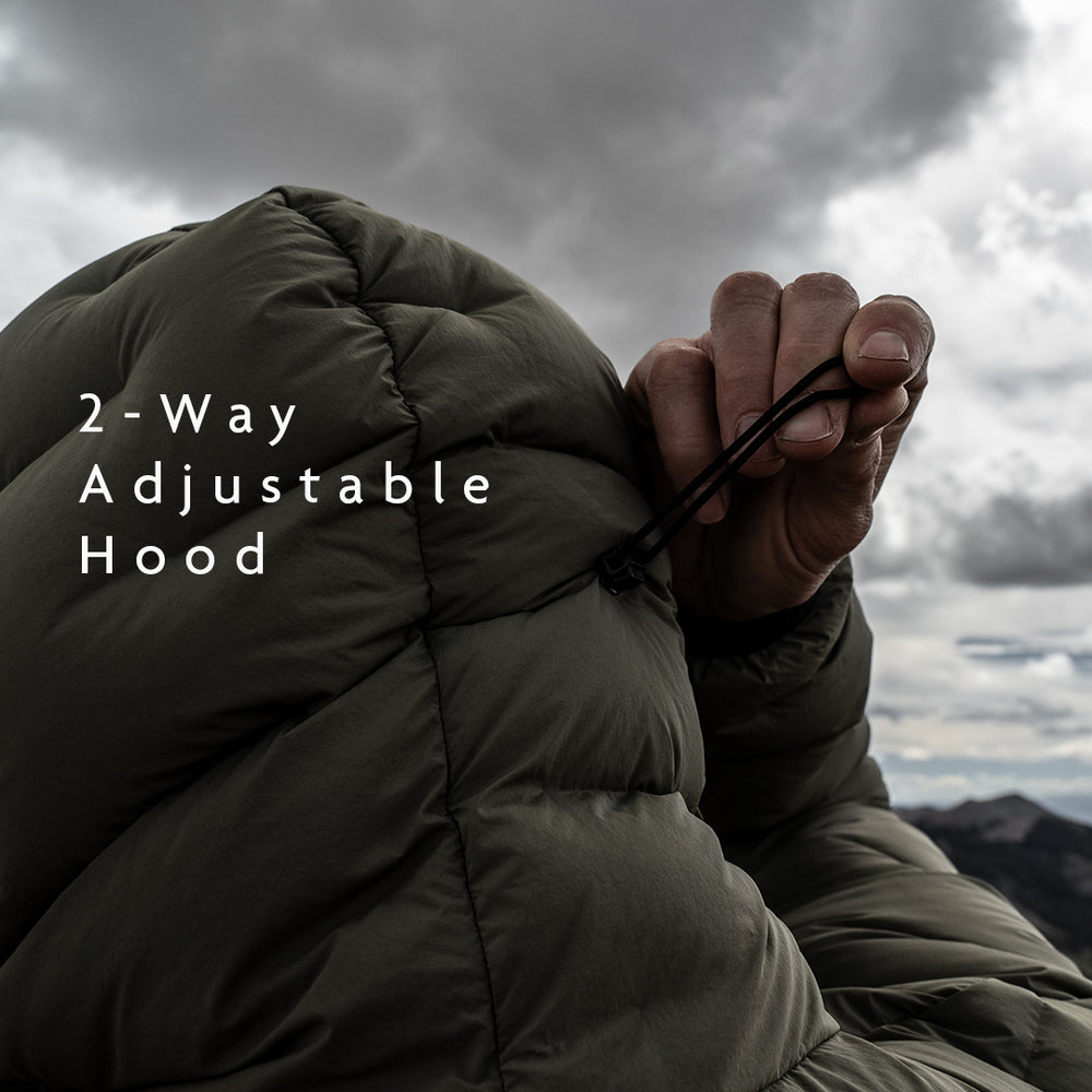 Hand pulling the rear adjustment cord on the Outdoor Vitals Vantage Alpine Down Jacket hood for a custom fit.