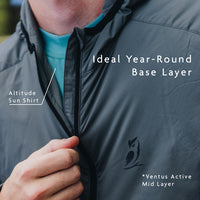 close up showing a person wearing a mid layer over sun shirt to demonstrate use as a base layer