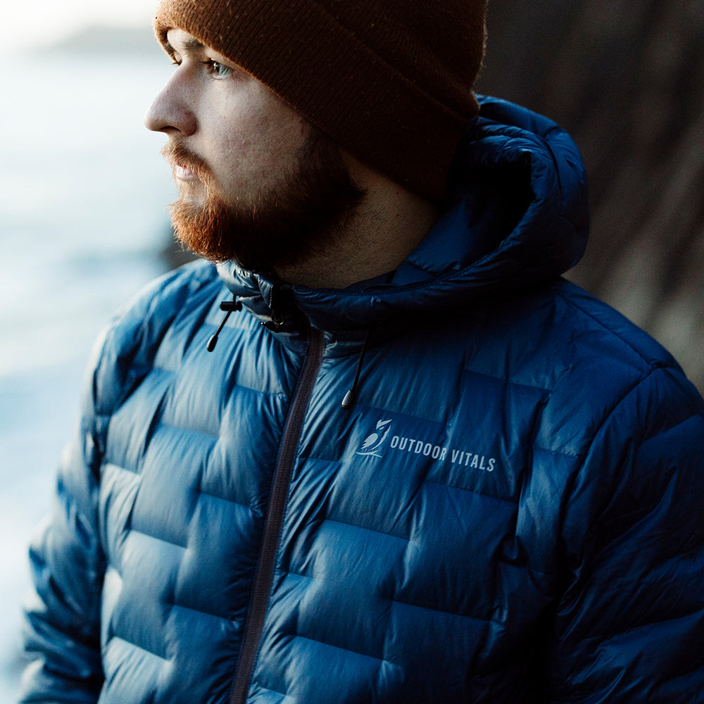 close view of man wearing blue ultralight puffy jacket with I beam baffles