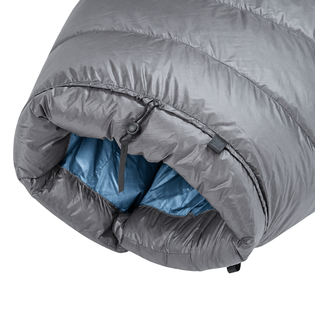 Detailed view of the cinched top neck collar with adjustable cord lock and insulated draft baffle on the blue Outdoor Vitals StormLoft Down TopQuilt.