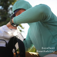 Turquoise - hiker wearing breathable sun shirt adjusting gear in backpack