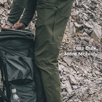 side view of lightweight green hiking pants with a side zipper vent and articulated knees