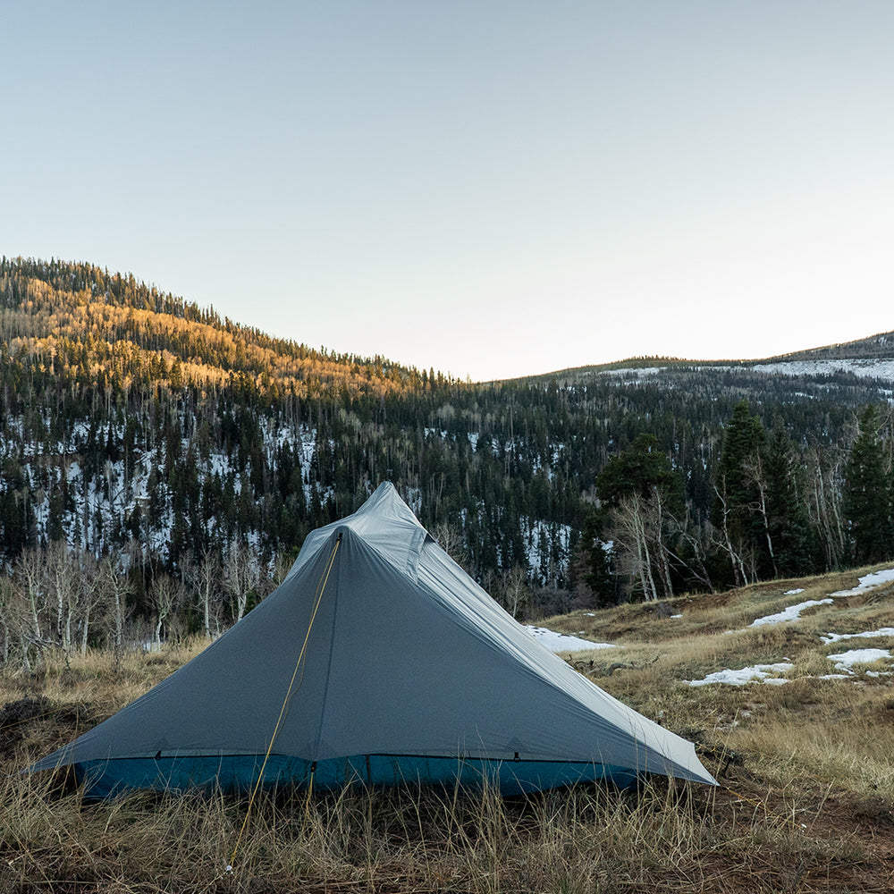 Ultralight trekking pole tent pitched in alpine mountain campsite
