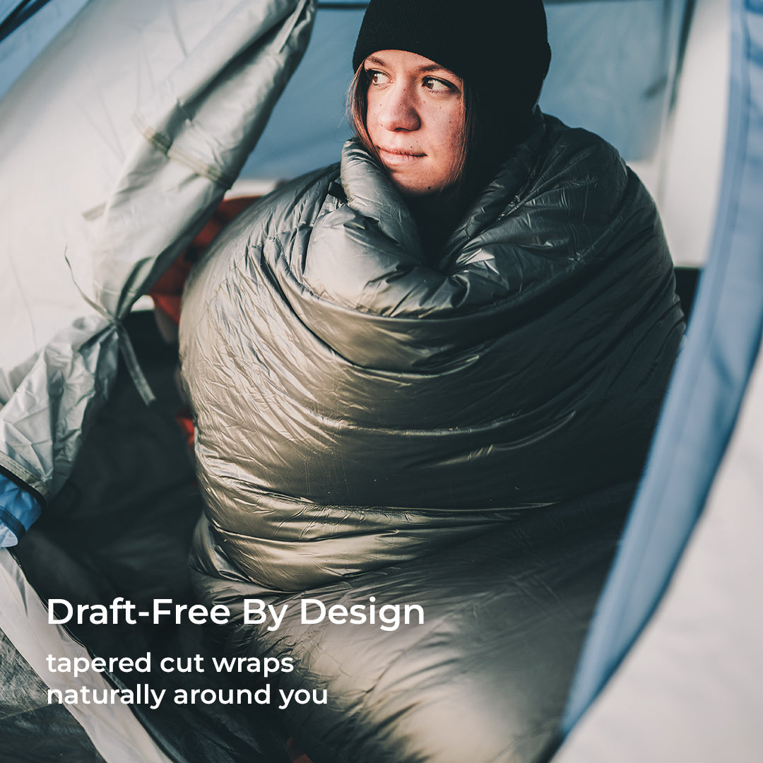 red 30 degree quilt wrapped around woman inside tent