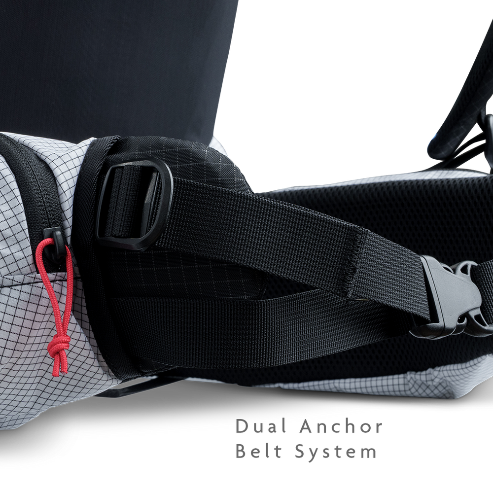 Close-up of backpack hip belt showing dual anchor belt system for improved load transfer.
