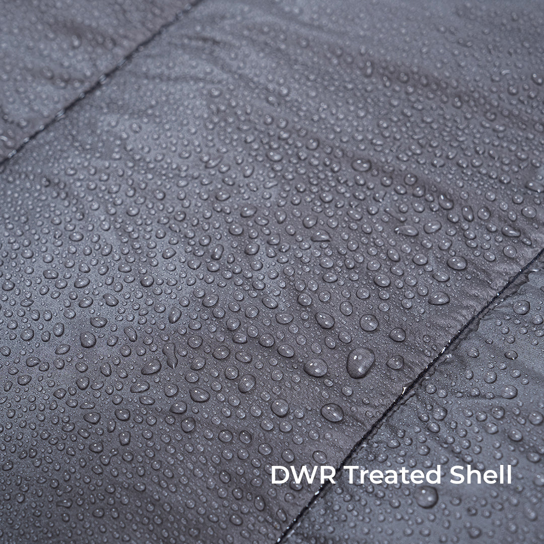 close view of water beading on the quilt fabric. Text says, "DWR Treated Shell." all-groups