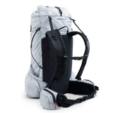 Angled rear view of ultralight backpack showing suspension system, shoulder straps, and hip belt.