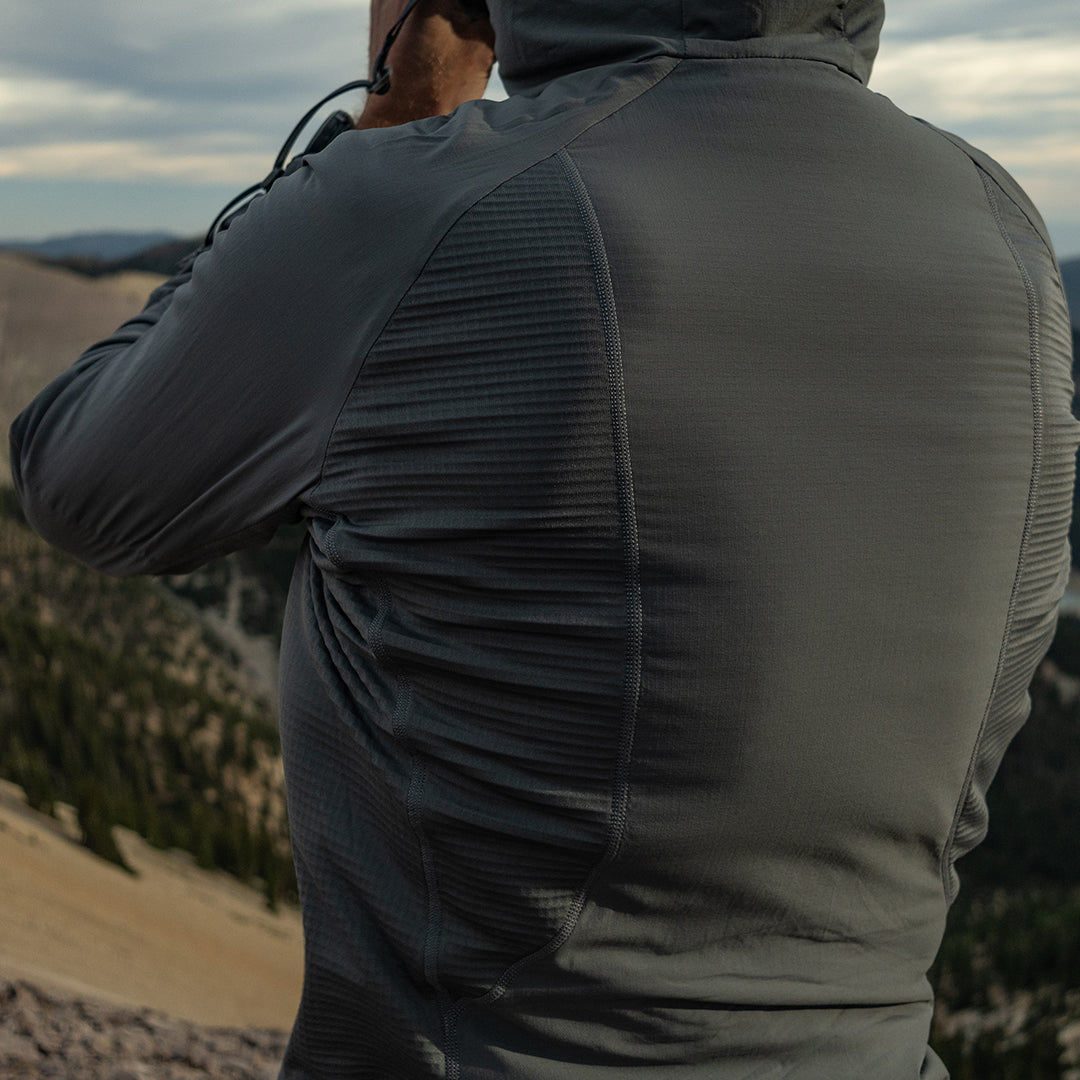 close rear view of gray hybrid fleece hoodie on man 