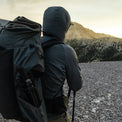 rear view of man wearing hybrid fleece hoodie on mountain peak